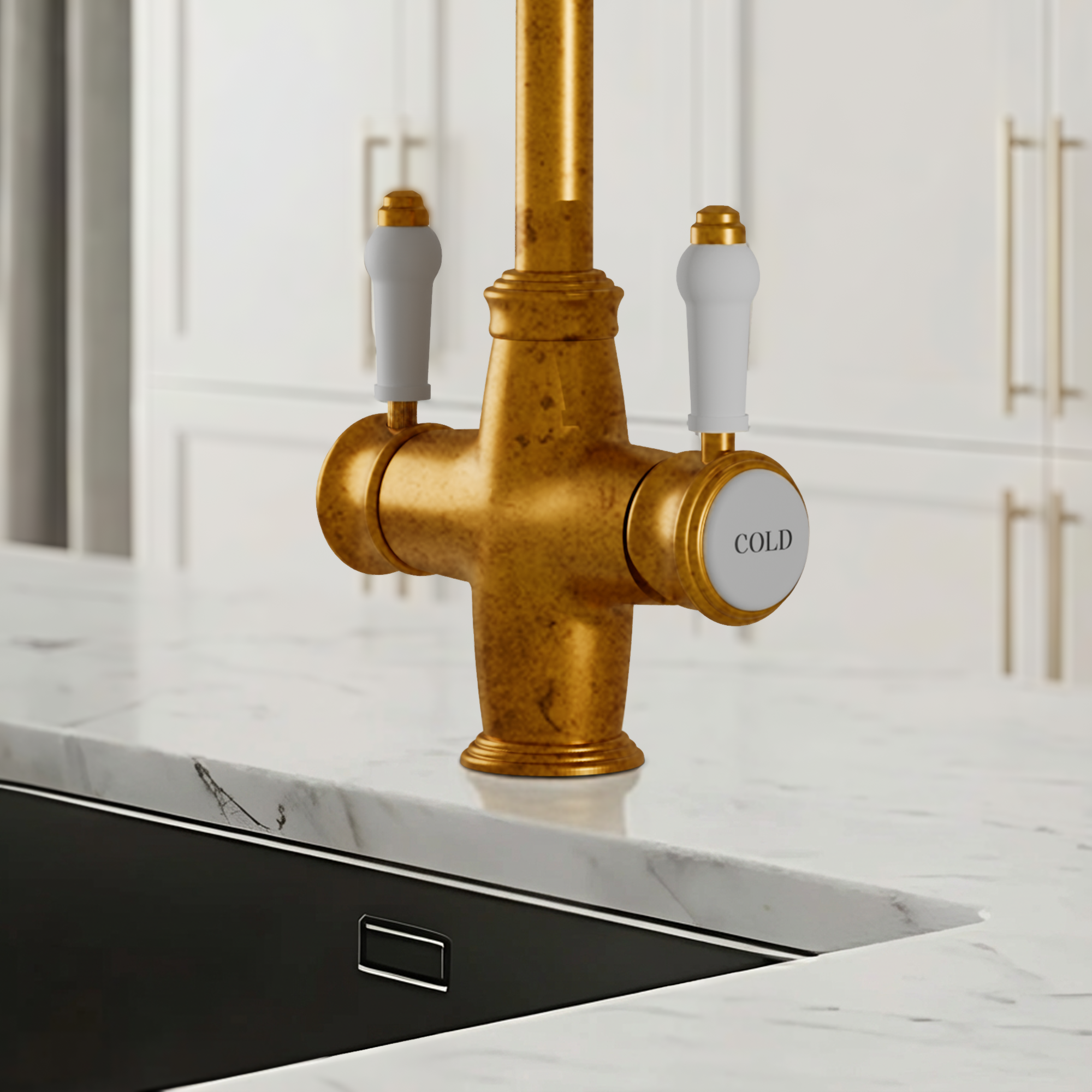 Gold kitchen faucet with white handles on a marble countertop